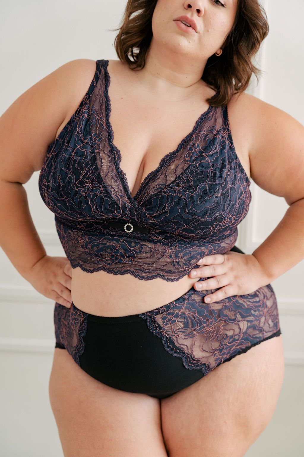 Fuller bust woman wearing blue and pink longline bra. #color_iris